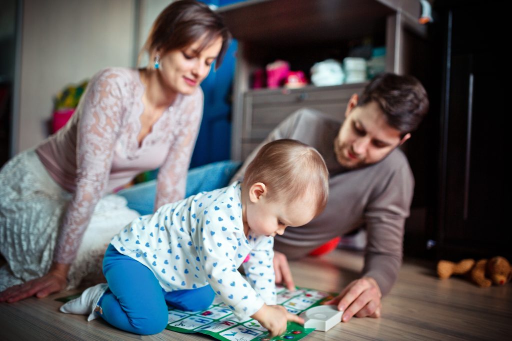 Young parents playing with child